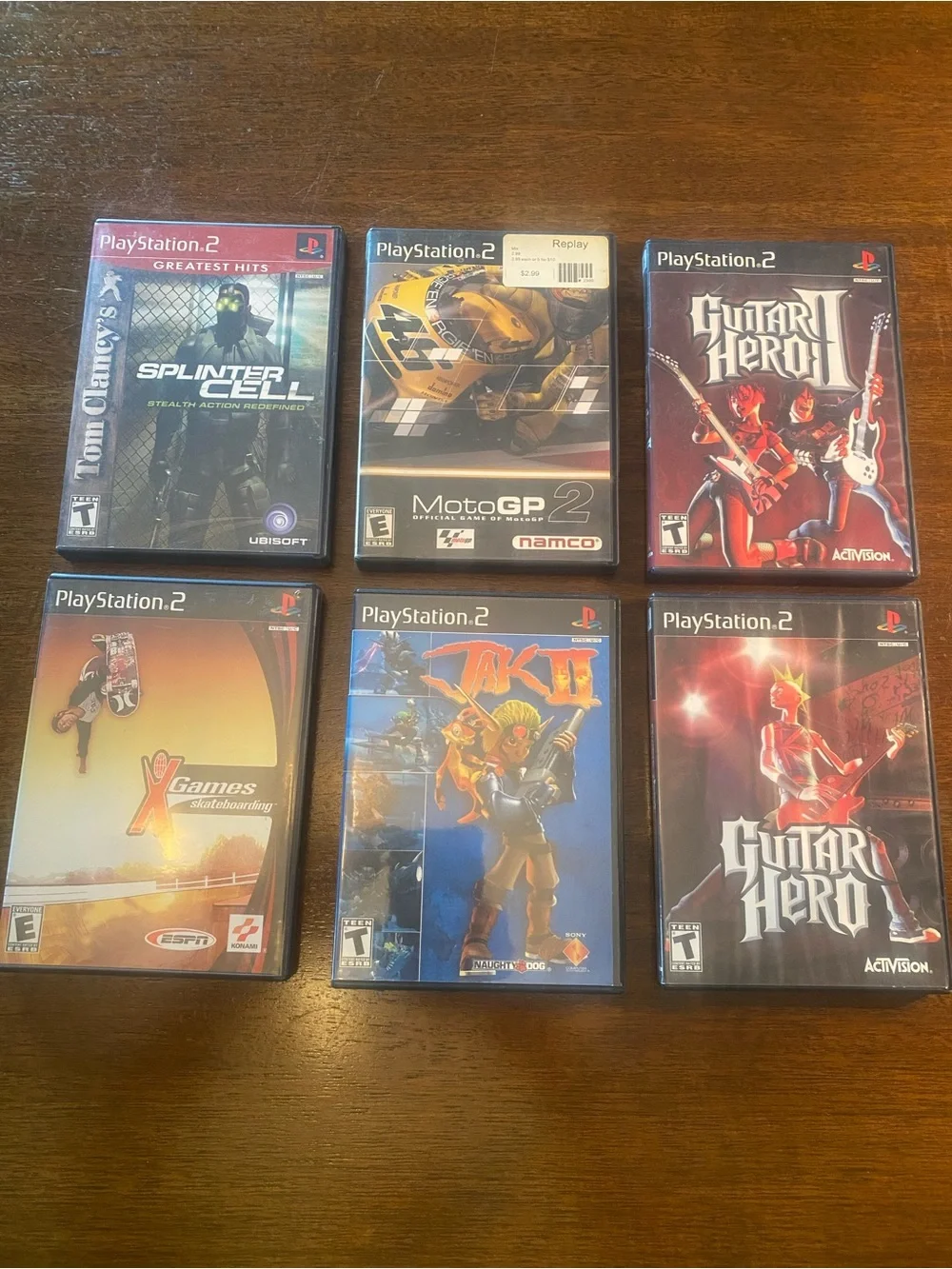 6 PS2 Jak II, Guitar Hero I & II, Splinter Cell, MotoGP 2, X Games Skateboarding